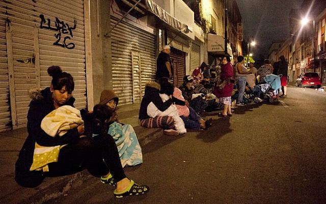 People gather on a street in downtown Mexico City during a magnitude 8.0 earthquake on September 7, 2017. (Pedro Pardo/AFP) People gather on a street in downtown Mexico City during a magnitude 8.0 earthquake on September 7, 2017. (Pedro Pardo/AFP)