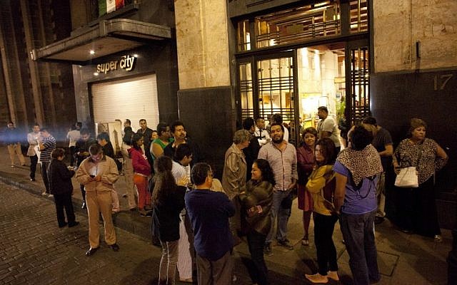 People gather on a street in downtown Mexico City during an earthquake on September 7, 2017. (AFP PHOTO / PEDRO PARDO) People gather on a street in downtown Mexico City during an earthquake on September 7, 2017. (AFP PHOTO / PEDRO PARDO)