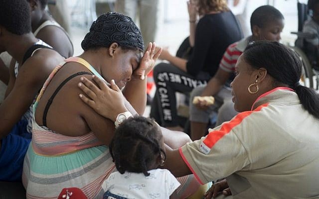 A member of the French Red Cross comforts a woman, who was evacuated from the island of Saint Martin that has been ravaged by Hurricane Irma, upon her arrival on September 9, 2017 at the Pole Caraibes international airport in Pointe-a-Pitre on the French Caribbean island of Guadeloupe.(AFP PHOTO / Helene Valenzuela) A member of the French Red Cross comforts a woman, who was evacuated from the island of Saint Martin that has been ravaged by Hurricane Irma, upon her arrival on September 9, 2017 at the Pole Caraibes international airport in Pointe-a-Pitre on the French Caribbean island of Guadeloupe.(AFP PHOTO / Helene Valenzuela)