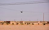 Illustrative: A Syrian military helicopter flys over the outskirts of the eastern city of Deir Ezzor, September 10, 2017. (AFP/George Ourfalian)