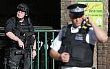Armed British police officers stand on duty outside Parsons Green underground tube station in west London on September 15, 2017, following a bombing on an underground tube carriage at the station. (AFP/ Daniel LEAL-OLIVAS)