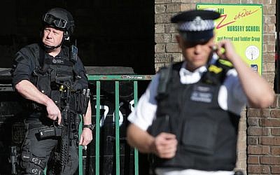 Armed British police officers stand on duty outside Parsons Green underground tube station in west London on September 15, 2017, following a bombing on an underground tube carriage at the station. (AFP/ Daniel LEAL-OLIVAS)