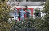 Police forensics officers works next to an underground train at a platform at Parsons Green underground station in west London on September 15, 2017, following an explosion, later claimed by Islamic State, which injured 29 people. (AFP/Daniel Leal-Olivas)