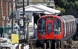 Police forensics officers works alongside an underground tube train at a platform at Parsons Green underground tube station in west London on September 15, 2017 following an explosion. (AFP/Adrian Dennis)