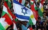 Iraqi Kurds fly an Israeli flag and Kurdish flags during an event to urge people to vote in the upcoming independence referendum in Erbil, the capital of the autonomous Kurdish region of northern Iraq, on September 16, 2017. (AFP/Safin Hamed)