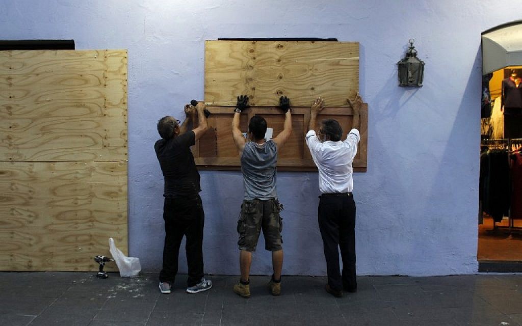 People board up windows of a business in preparation for the anticipated arrival of Hurricane Maria in San Juan, Puerto Rico on September 18, 2017. (AFP PHOTO/Ricardo ARDUENGO) People board up windows of a business in preparation for the anticipated arrival of Hurricane Maria in San Juan, Puerto Rico on September 18, 2017. (AFP PHOTO/Ricardo ARDUENGO)