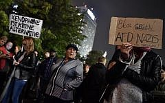 A protester holds up a sign reading 'Xenophobia is not an alternative' and '80 percent against AfD nazis' during a protest outside an election event of the Alternative for Germany (AfD) party in Berlin after the general election on September 24, 2017. AFP/ John MACDOUGALL)