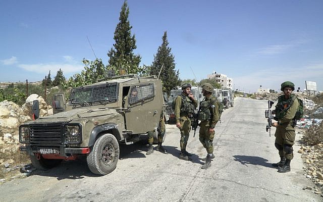 IDF soldiers impose a closure on the Palestinian village of Bayt Surik after a resident carried out a terror attack at a nearby Israeli settlement in which three people were killed on September 26, 2017. (Israel Defense Forces) IDF soldiers impose a closure on the Palestinian village of Bayt Surik after a resident carried out a terror attack at a nearby Israeli settlement in which three people were killed on September 26, 2017. (Israel Defense Forces)