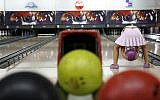 A young girl bowling in Jerusalem on Saturday 12. 2006. (Nati Shohat/Flash90)