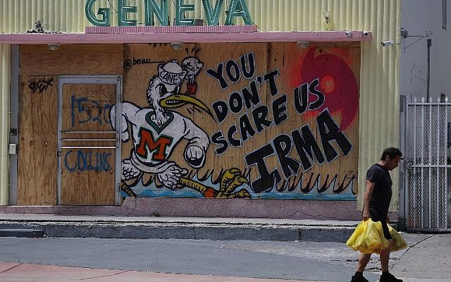 A message reading "You Don't Scare Us Irma" is written on plywood being used to cover the windows of a building as people prepare for the arrival of Hurricane Irma on September 8, 2017 in Miami Beach, Florida. (Joe Raedle/Getty Images/AFP) A message reading "You Don't Scare Us Irma" is written on plywood being used to cover the windows of a building as people prepare for the arrival of Hurricane Irma on September 8, 2017 in Miami Beach, Florida. (Joe Raedle/Getty Images/AFP)