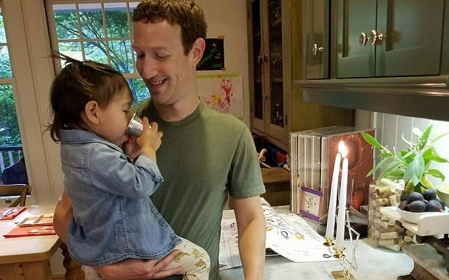 Mark Zuckerberg with his daughter Maxima in front of the Shabbat candles, September 15, 2017. (Facebook) Mark Zuckerberg with his daughter Maxima in front of the Shabbat candles, September 15, 2017. (Facebook)