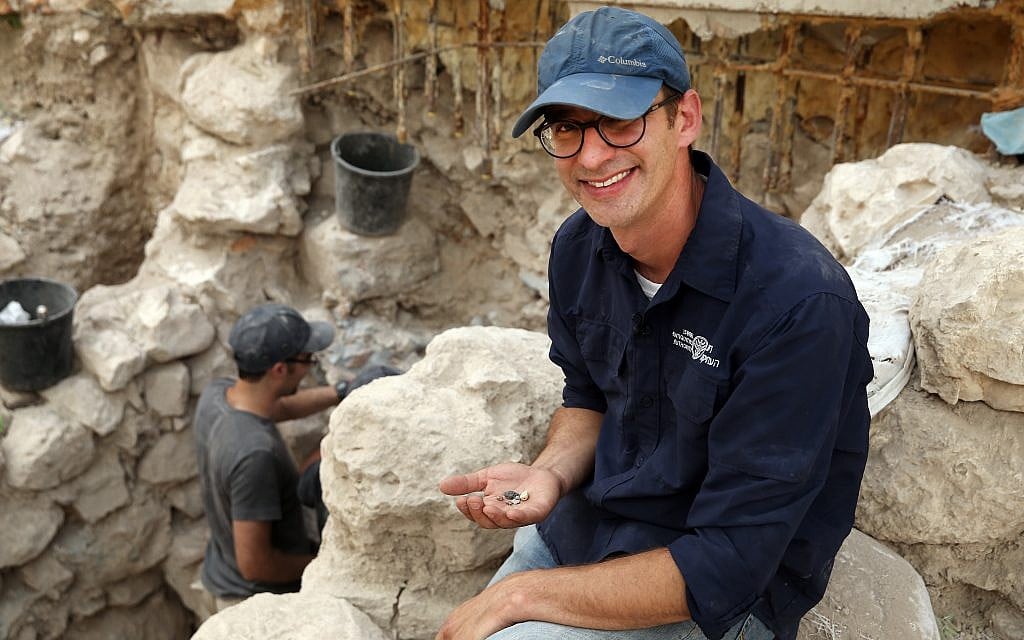 Israel Antiquities Authority' Dr. Joel Uziel holds a collection of First Temple period bullae (sealings) at Jerusalem's City of David, August 2017. (Eliyahu Yanai, City of David)