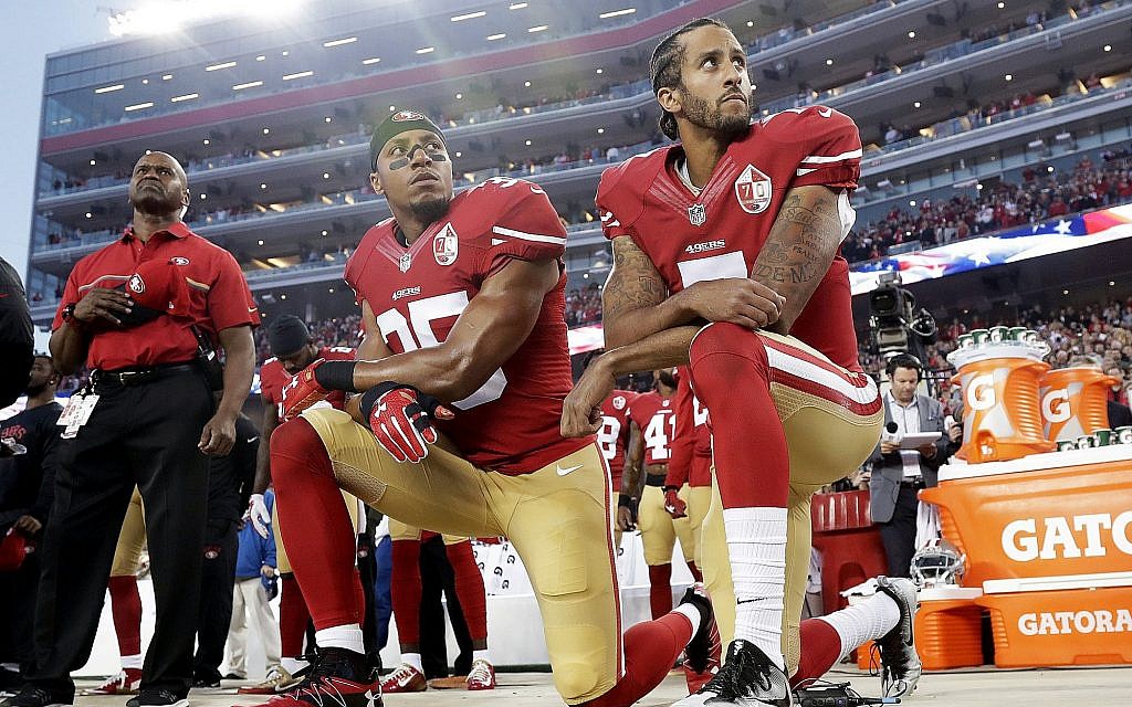 Int his Monday, September 12, 2016, file photo, San Francisco 49ers safety Eric Reid (L) and quarterback Colin Kaepernick (R) kneel during the national anthem before an NFL football game against the Los Angeles Rams in Santa Clara, California. (AP Photo/Marcio Jose Sanchez) Int his Monday, September 12, 2016, file photo, San Francisco 49ers safety Eric Reid (L) and quarterback Colin Kaepernick (R) kneel during the national anthem before an NFL football game against the Los Angeles Rams in Santa Clara, California. (AP Photo/Marcio Jose Sanchez)