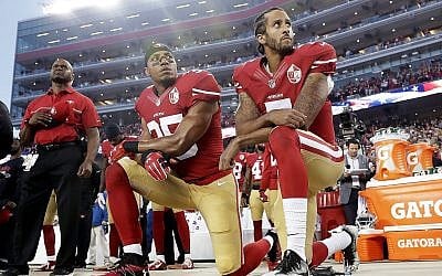 Int his Monday, September 12, 2016, file photo, San Francisco 49ers safety Eric Reid (L) and quarterback Colin Kaepernick (R) kneel during the national anthem before an NFL football game against the Los Angeles Rams in Santa Clara, California. (AP Photo/Marcio Jose Sanchez)