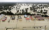 Water from Addicks Reservoir flows into neighborhoods as floodwaters from Tropical Storm Harvey rise in Houston, Texas, August 29, 2017. (AP/David J. Phillip)