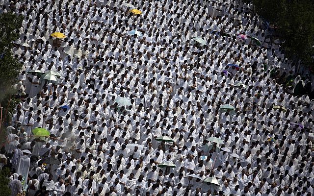 Muslim pilgrims attend noon prayers outside the Namirah mosque on Arafat Mountain, during the annual hajj pilgrimage, outside the holy city of Mecca, Saudi Arabia, Thursday, Aug. 31, 2017. (AP Photo/Khalil Hamra)