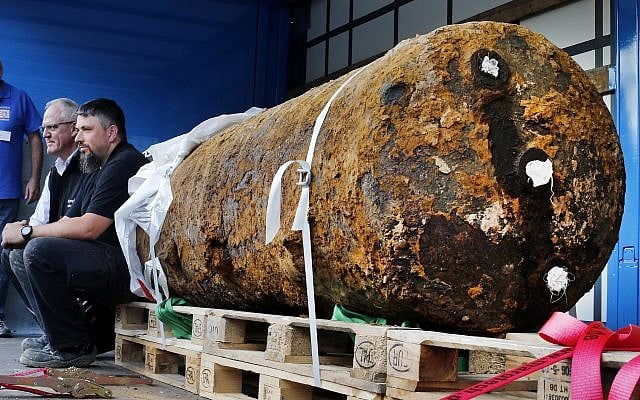Disposers Dieter Schwaetzler, left, and Rene Bennert sit next to 1.8 ton WWII bomb right after they defused it, in Frankfurt, Germany, Sunday, Sept. 3, 2017. (AP/Michael Probst) Disposers Dieter Schwaetzler, left, and Rene Bennert sit next to 1.8 ton WWII bomb right after they defused it, in Frankfurt, Germany, Sunday, Sept. 3, 2017. (AP/Michael Probst)