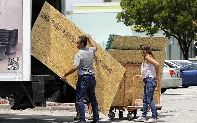 Residents load sheets of strand board on a truck as they prepare for Hurricane Irma, September 5, 2017, in Hialeah, Florida. (AP Photo/Alan Diaz) Residents load sheets of strand board on a truck as they prepare for Hurricane Irma, September 5, 2017, in Hialeah, Florida. (AP Photo/Alan Diaz)