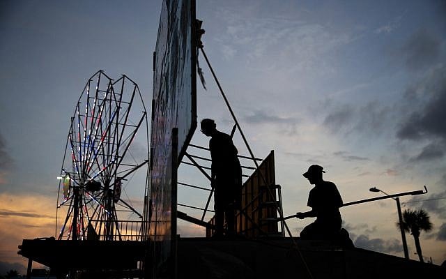 Workers dismantle the facade of a funhouse at an amusement park ahead of Hurricane Irma in Daytona Beach, Fla., Thursday, Sept. 7, 2017. (AP Photo/David Goldman) Workers dismantle the facade of a funhouse at an amusement park ahead of Hurricane Irma in Daytona Beach, Fla., Thursday, Sept. 7, 2017. (AP Photo/David Goldman)