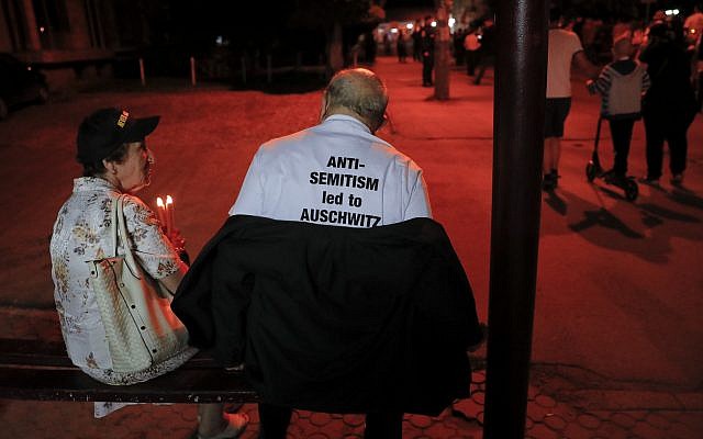 A couple takes a break during a march marking one year since the death of Nobel laureate and Holocaust survivor Elie Wiesel in Sighetu Marmatiei, northern Romania, Sunday, September 10, 2017. (AP Photo/Vadim Ghirda) A couple takes a break during a march marking one year since the death of Nobel laureate and Holocaust survivor Elie Wiesel in Sighetu Marmatiei, northern Romania, Sunday, September 10, 2017. (AP Photo/Vadim Ghirda)