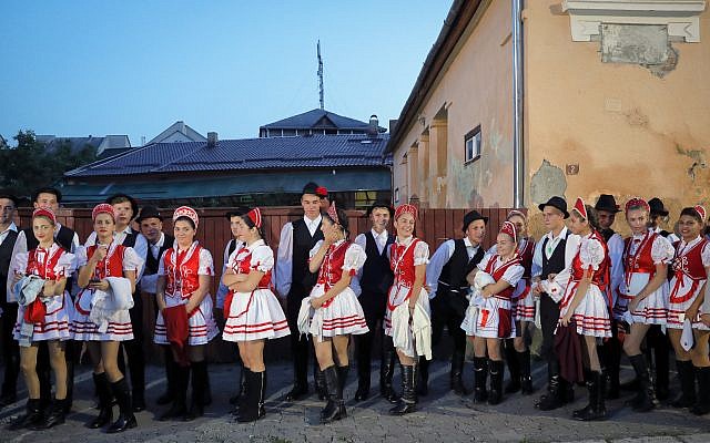 Youngsters wearing traditional costumes wait before a march marking one year since the death of Nobel laureate and Holocaust survivor Elie Wiesel in Sighetu Marmatiei, northern Romania, Sunday, September 10, 2017. (AP Photo/Vadim Ghirda) Youngsters wearing traditional costumes wait before a march marking one year since the death of Nobel laureate and Holocaust survivor Elie Wiesel in Sighetu Marmatiei, northern Romania, Sunday, September 10, 2017. (AP Photo/Vadim Ghirda)