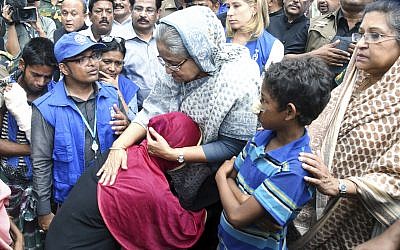 Bangladeshi Prime Minister Sheikh Hasina, center, meets with Rohingya Muslims at Kutupalong refugee camp, near the border town of Ukhia, Bangladesh, Tuesday, Sept. 12, 2017. (AP Photo/Saiful Kallol)
