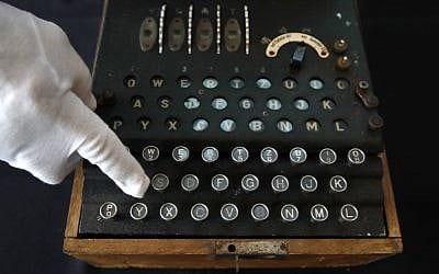 H. Keith Melton points to a key on an Enigma Machine with four rotors and a some Japanese characters that was used in World War II to encode messages, September 13, 2017, in Washington. (AP Photo/Jacquelyn Martin)