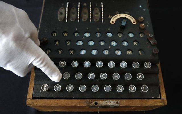 H. Keith Melton points to a key on an Enigma Machine with four rotors and a some Japanese characters that was used in World War II to encode messages, September 13, 2017, in Washington. (AP Photo/Jacquelyn Martin)