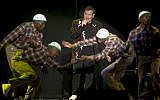 In this photo taken Saturday, July 2017, South African musician Johnny Clegg, middle, and the dancers perform during "The Final Journey" concert at the Grand Arena in Cape Town, South Africa. (AP Photo)
