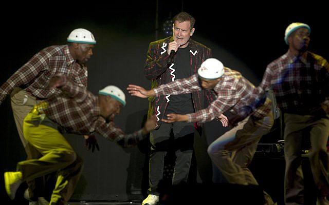 In this photo taken Saturday, July 2017, South African musician Johnny Clegg, middle, and the dancers perform during "The Final Journey" concert at the Grand Arena in Cape Town, South Africa. (AP Photo) In this photo taken Saturday, July 2017, South African musician Johnny Clegg, middle, and the dancers perform during "The Final Journey" concert at the Grand Arena in Cape Town, South Africa. (AP Photo)