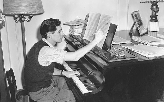 In this February 24, 1945, file photo American-born conductor, composer, and pianist Leonard Bernstein works on a new musical score in his West Side apartment in New York City. (AP Photo, File)