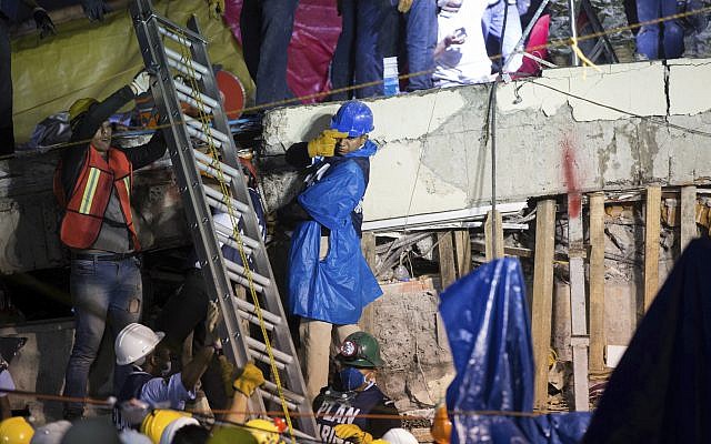 A ladder is raised to search and rescue team members during rescue efforts at the Enrique Rebsamen school in Mexico City, Mexico, Thursday, Sept. 21, 2017. (AP Photo/Anthony Vazquez) A ladder is raised to search and rescue team members during rescue efforts at the Enrique Rebsamen school in Mexico City, Mexico, Thursday, Sept. 21, 2017. (AP Photo/Anthony Vazquez)