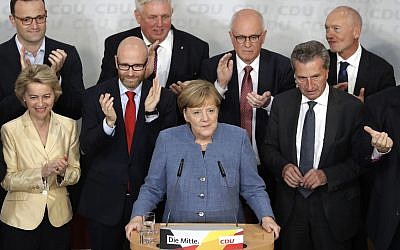 German Chancellor Angela Merkel is surrounded by party board members as she delivers a speech, after the German parliament elections at the headquarters of the Christian Democratic Union CDU in Berlin, Germany, September 24, 2017. (AP Photo/Matthias Schrader)