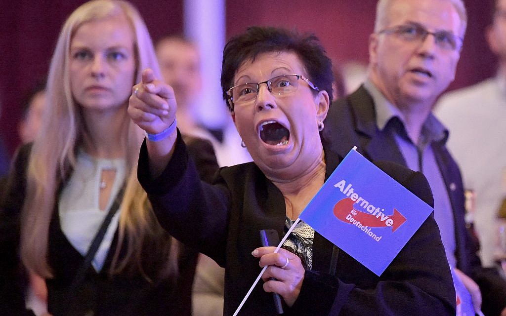 Guests at an Alternative for Germany party, AfD election party react to the first projections for the German election in Erfurt, Germany, September 24, 2017. (Martin Schutt/dpa via AP) Guests at an Alternative for Germany party, AfD election party react to the first projections for the German election in Erfurt, Germany, September 24, 2017. (Martin Schutt/dpa via AP)