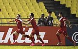 Syria's Mahmoud Almawas, left, celebrates scoring against China during the Group A World Cup qualifying soccer match in Melaka, Malaysia, Tuesday, June 13, 2017. (AP Photo/Vincent Thian)