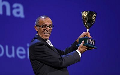 Kamel El Basha holds aloft the Volpi Cup for best actor for his role in 'The Insult' during the award ceremony at the 74th Venice Film Festival at the Venice Lido, Italy, Saturday, Sept. 9, 2017. (AP Photo/Domenico Stinellis)