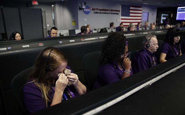 Engineer Nancy Vandermay, left, wipes her tears in mission control at NASA's Jet Propulsion Laboratory after confirmation of Cassini's demise Friday, Sept. 15, 2017, in Pasadena , Calif. (Jae C. Hong, Pool/AP) Engineer Nancy Vandermay, left, wipes her tears in mission control at NASA's Jet Propulsion Laboratory after confirmation of Cassini's demise Friday, Sept. 15, 2017, in Pasadena , Calif. (Jae C. Hong, Pool/AP)