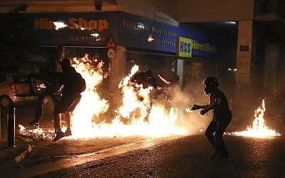Protesters are engulfed in flames as they throw petrol bombs at police during an anti-fascist rally, commemorating the killing of Greek rap singer Pavlos Fyssas, in Athens, September 16, 2017. (AP Photo/Yorgos Karahalis)