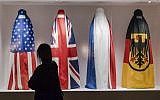 A Visitor walks by an installation by Haitian artist Jean Ulrick Desert, titled The Burqa Project-On The Borders of My Dreams I Encountered My Double's Ghost for an exhibition "Islam, It's Also Our History" at the Espace Vanderborght in Brussels on Tuesday, Sept. 19, 2017. (Geert Vanden Wijngaert/AP)