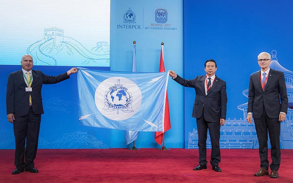 A Palestinian delegate receives the Interpol flag from the president of the International Criminal Police Organization Meng Hongwei, second right, during the Interpol General Assembly, in Beijing, China, September 27, 2017. (Interpol via AP) A Palestinian delegate receives the Interpol flag from the president of the International Criminal Police Organization Meng Hongwei, second right, during the Interpol General Assembly, in Beijing, China, September 27, 2017. (Interpol via AP)