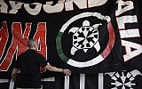 In this photo taken on September 9, 2017, a banner showing a turtle, the symbol of neo-fascist movement CasaPound, is hung at the group's national meeting in Borgo Sabotino, near Latina, Italy. (AP Photo/Alessandra Tarantino)
