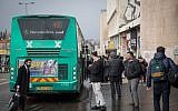 Illustrative: People wait for the bus outside Jerusalem's Central Bus Station on January 4, 2017. (Hadas Parush/Flash90)