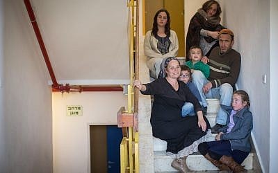 The Ziv family, who were among those evacuated from the illegal Amona outpost, pose for a photo with their children in their temporary residence in the Ofra settlement on February 10, 2017. (Hadas Parush/Flash90)