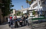 Border Police officers check the ID of Palestinian women at the entrance to the Tomb of the Patriarchs in the West Bank city of Hebron on July 9, 2017. (Miriam Alster/Flash90)