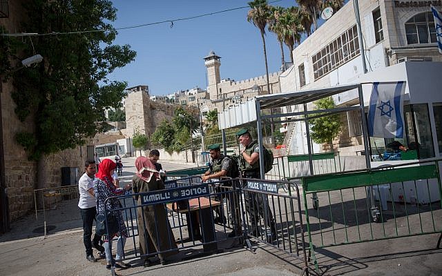 Border Police officers check the ID of Palestinian women at the entrance to the Tomb of the Patriarchs in the West Bank city of Hebron on July 9, 2017. (Miriam Alster/Flash90) Border Police officers check the ID of Palestinian women at the entrance to the Tomb of the Patriarchs in the West Bank city of Hebron on July 9, 2017. (Miriam Alster/Flash90)