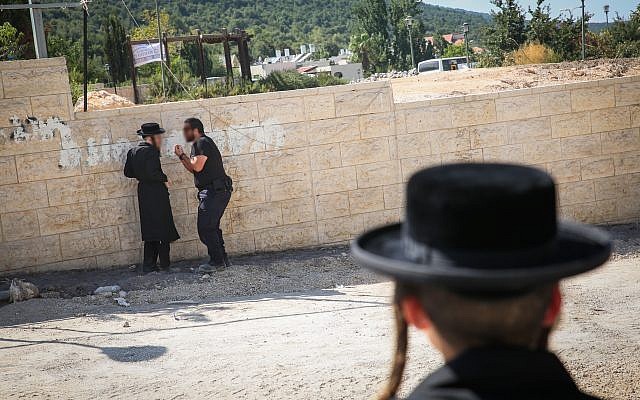 Illustrative: A police officer confronts an ultra-Orthodox protester at a construction site in Meron, northern Israel, on August 16, 2017. (David Cohen/Flash90) Illustrative: A police officer confronts an ultra-Orthodox protester at a construction site in Meron, northern Israel, on August 16, 2017. (David Cohen/Flash90)