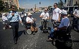 Disabled people and their supporters block the entrance to Jerusalem in protest of inadequate stipends, September 7, 2017. (Yonatan Sindel/Flash90)