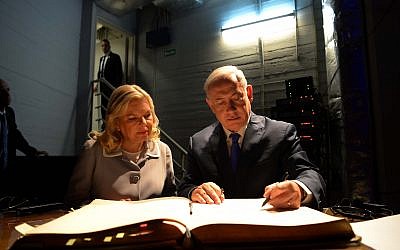 Israeli Prime Minister Benjamin Netanyahu and his wife Sara sign the guest book during a visit at the Israeli embassy in Buenos Aires, Argentina, on September 11, 2017 (Avi Ohayon/GPO)