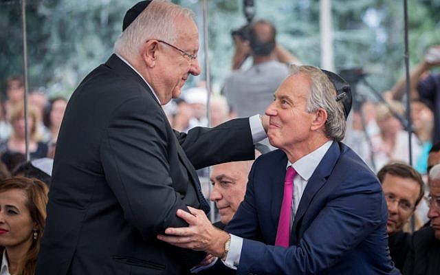 President Reuven Rivlin and ex-British PM Tony Blair shake hands during a ceremony marking one year since the death of late former president Shimon Peres, at Mount Herzl in Jerusalem, on September 14, 2017. (Yonatan Sindel/Flash90)