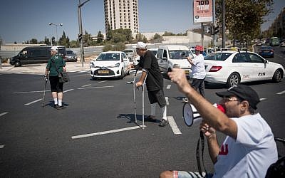 Disabled activists block a road in Jerusalem on September 18, 2017. (Yonatan Sindel/Flash90)